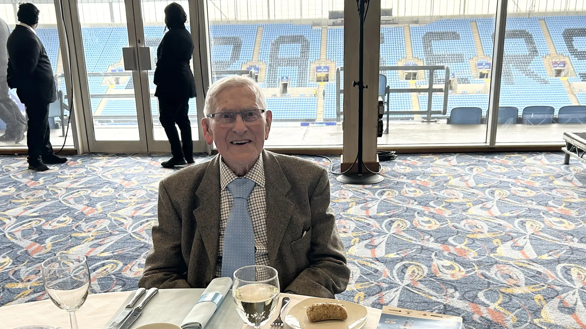 Man at dining table in Coventry stadium