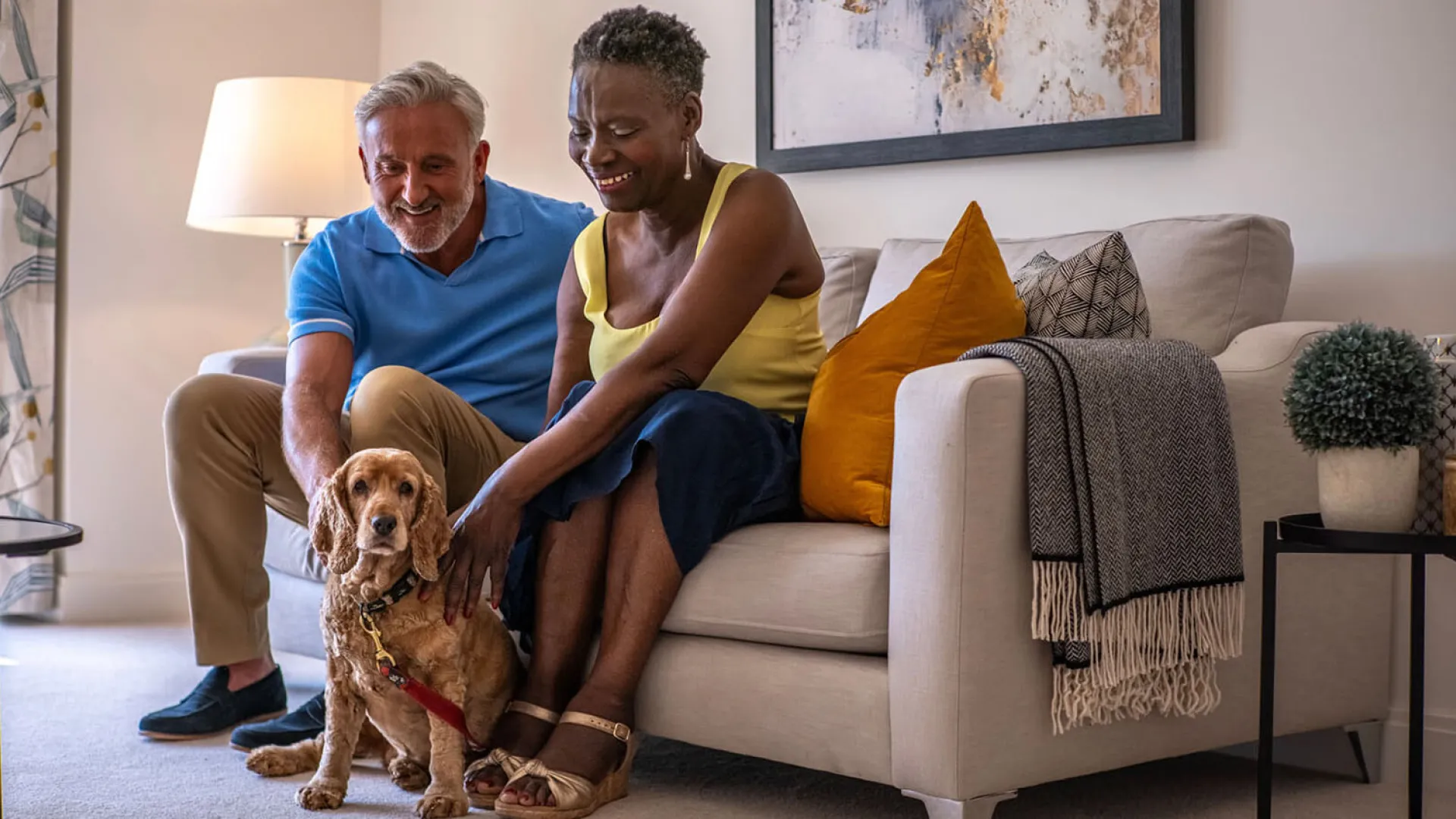 Couple with dog on sofa