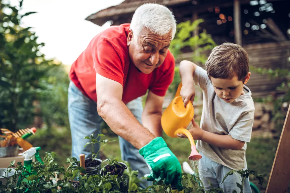 Man gardening with child