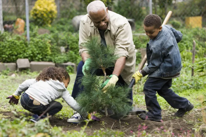 Man and 2 kids gardening