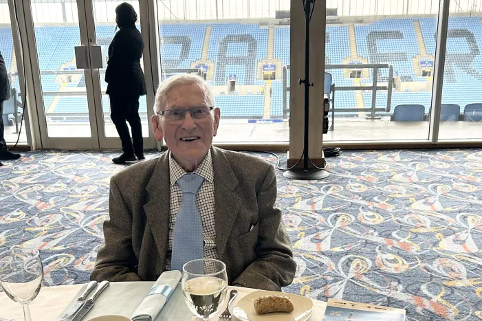Man at dining table in Coventry stadium