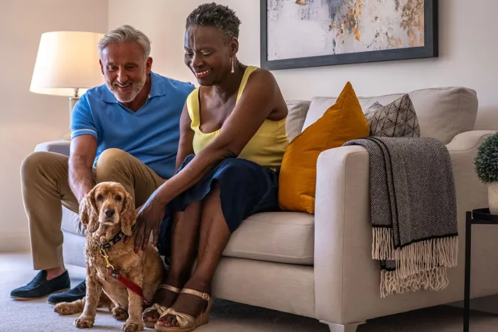 Couple with dog on sofa