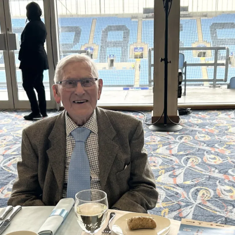 Man at dining table in Coventry stadium