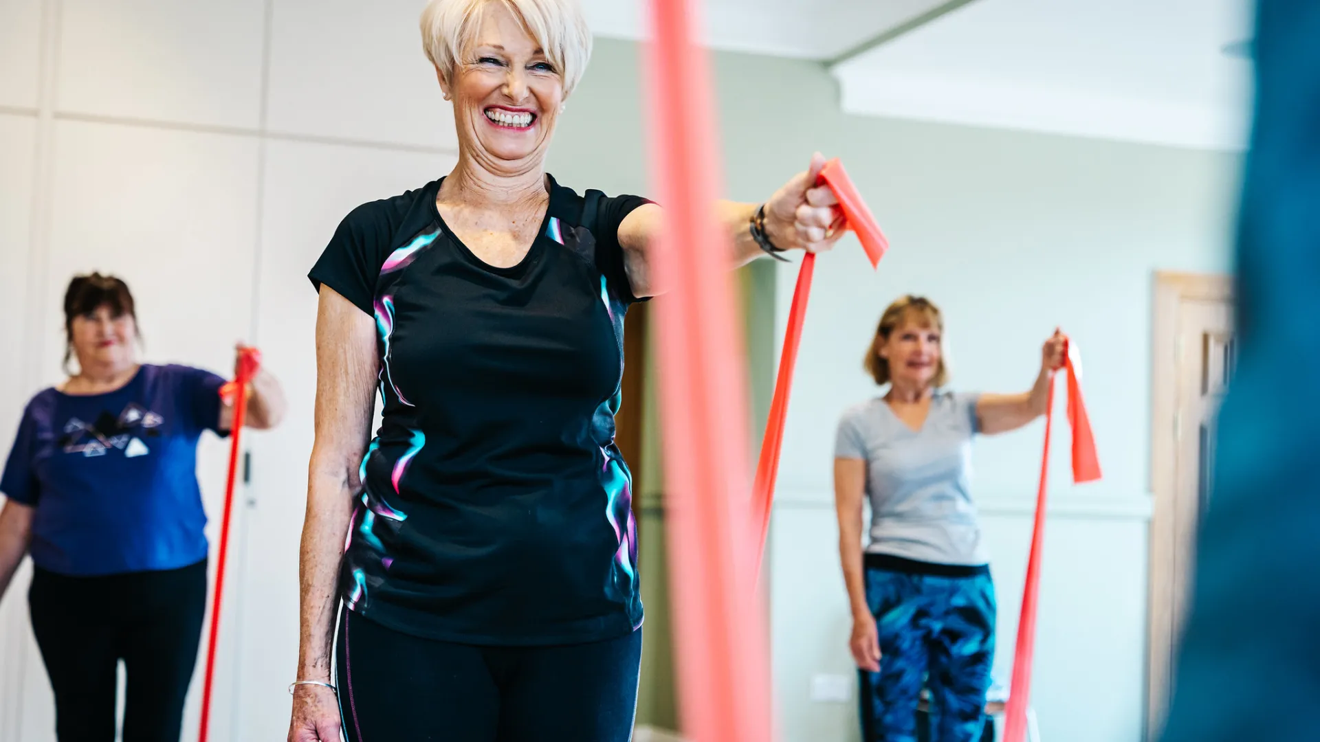A woman smiling during an exercise class