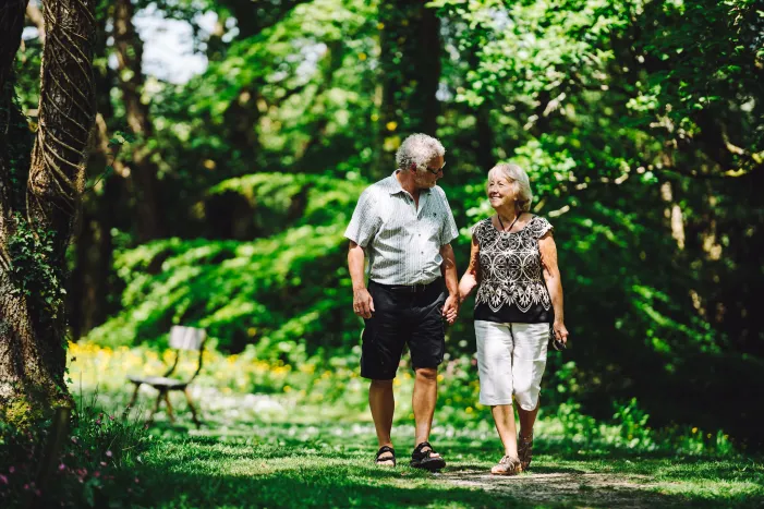 Couple walking through forest