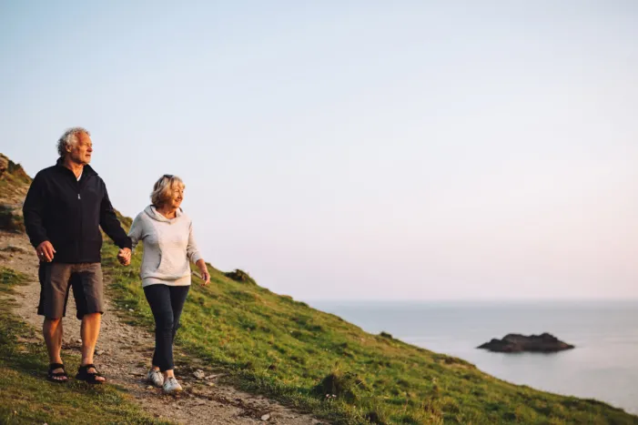 A couple walking on the coast in Devon