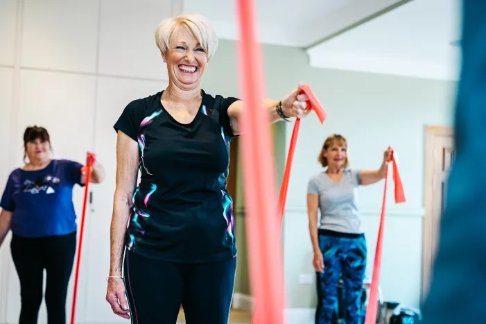 A woman smiling during an exercise class